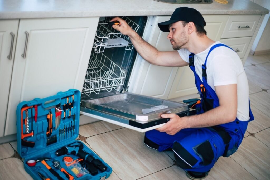ABS technician repairing a Cove dishwasher filter system in a Los Angeles home kitchen