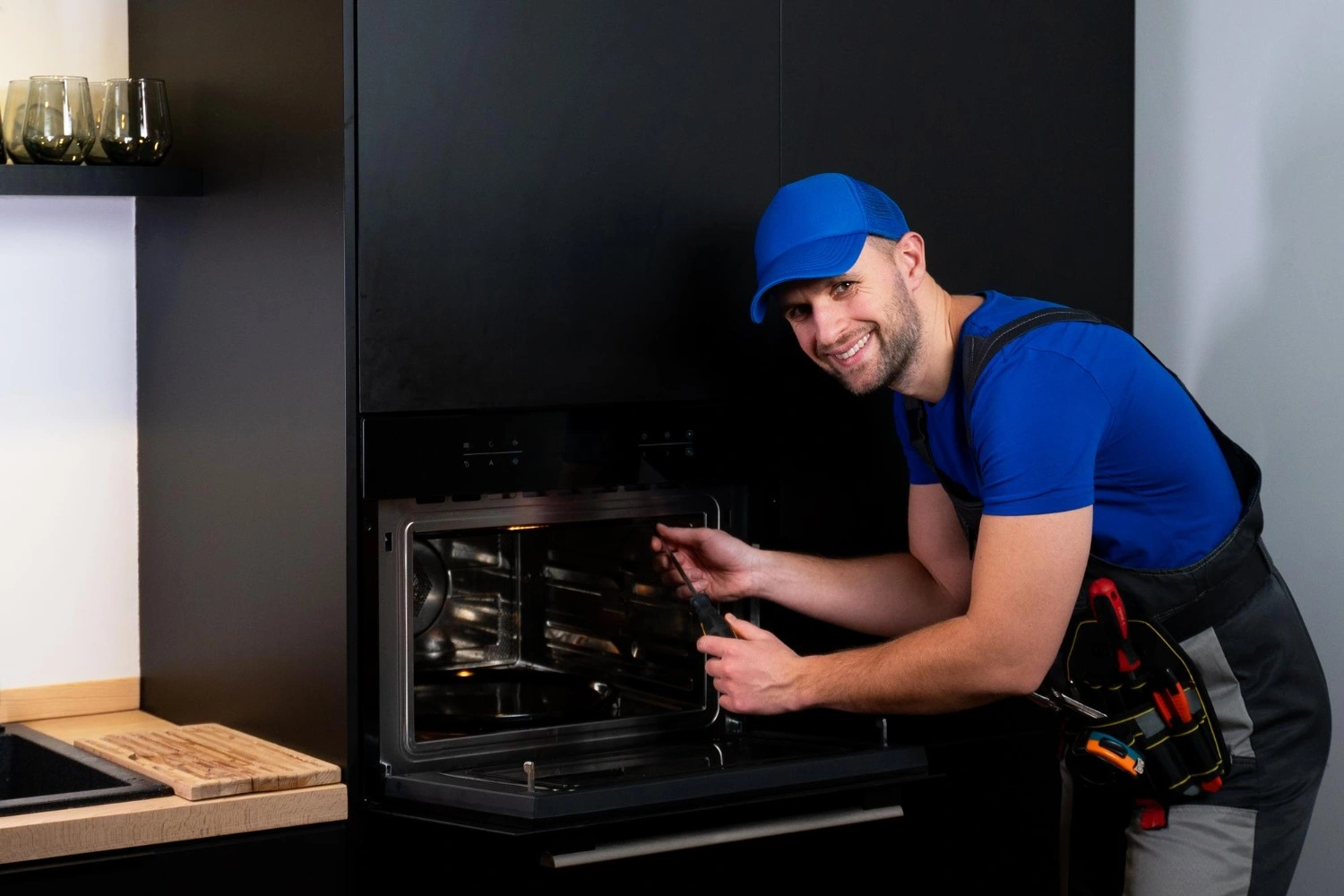 man repairing appliance