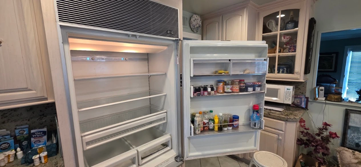 Sub Zero Repair Cost - Technician diagnosing a built-in Sub-Zero refrigerator during an in-home repair visit in Los Angeles